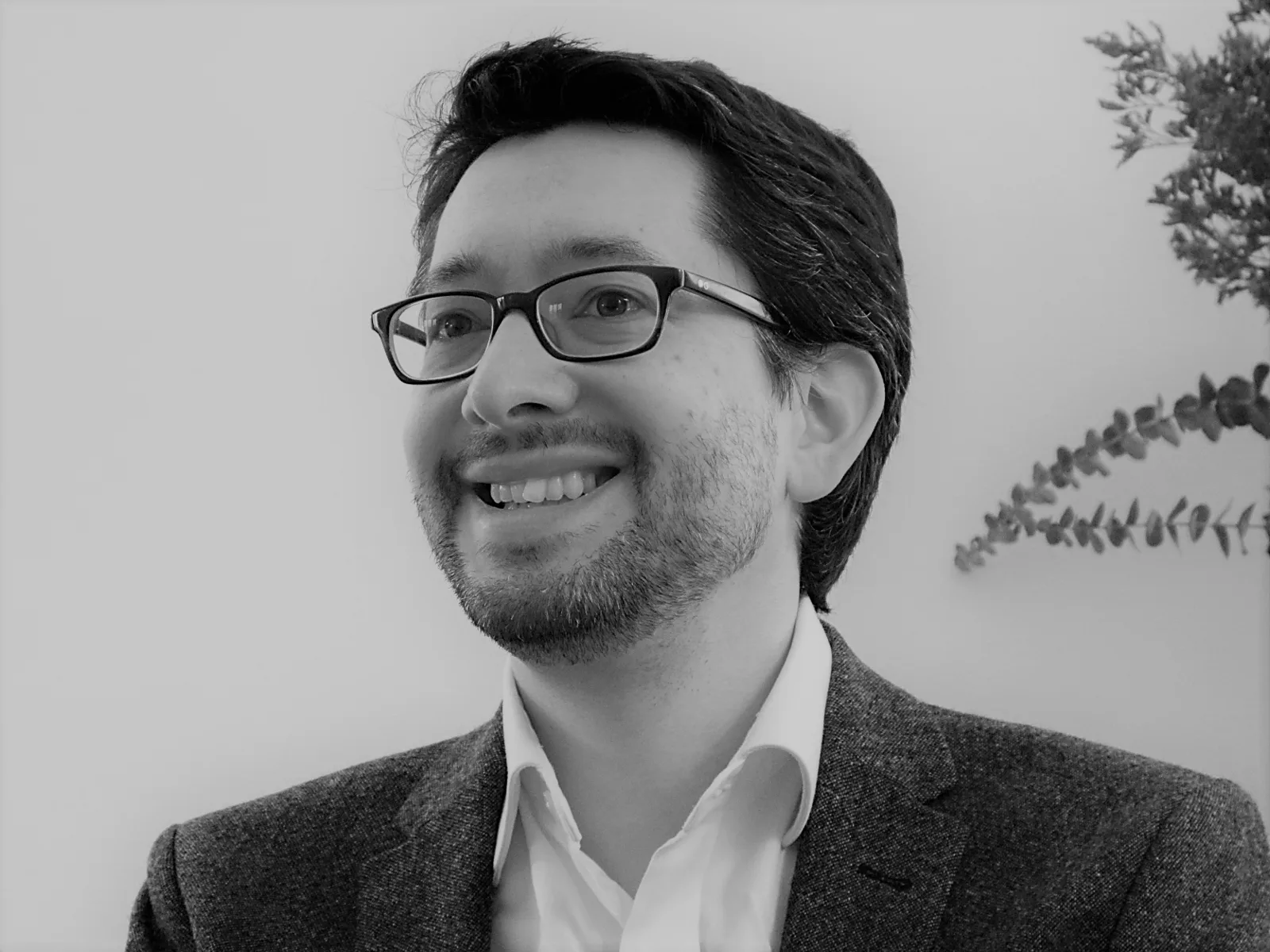 Headshot with grey jacket smile 6_small_B&W_2mp.png